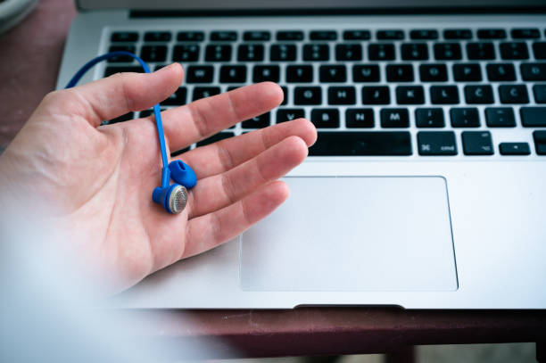 istock Hand holding earphone with detached ear tip 1335544717
