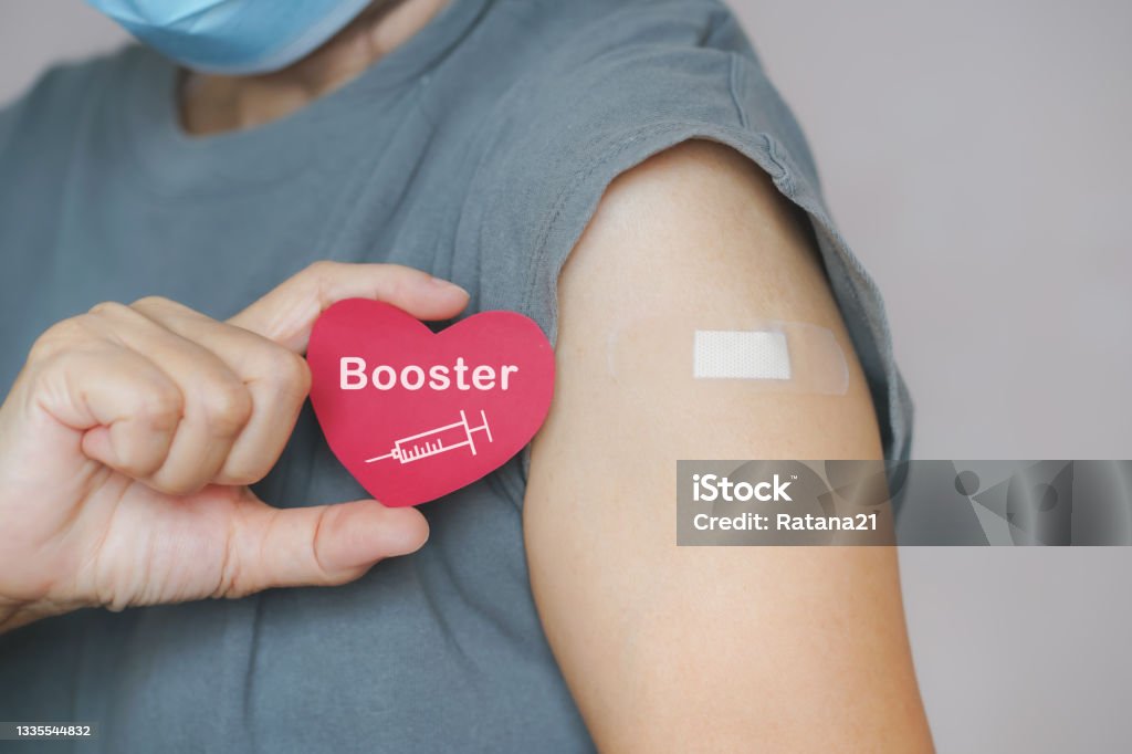 senior woman show red heart shape with syringe icon,  after vaccinated or inoculation  booster dose  due to spread of corona virus, population, social or herd immunity concept Booster Dose Stock Photo