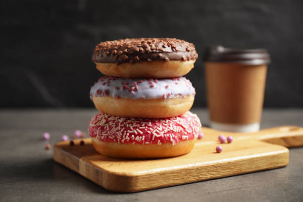 istock Sweet delicious glazed donuts on grey table 1335545805