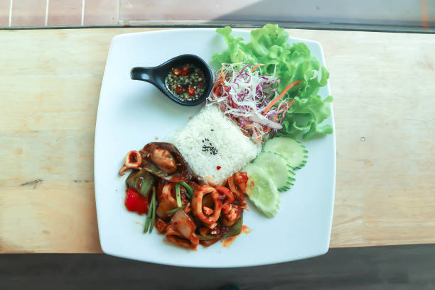 istock stir fried squid and mussel with rice and vegetable, spicy squid and mussel 1335548584