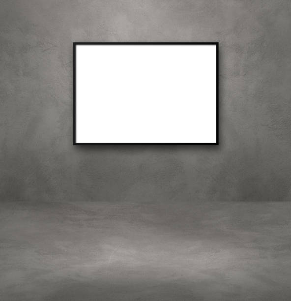 istock Black picture frame hanging on a dark concrete wall 1335548637