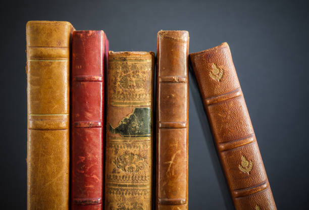 istock Row of old books on dark background 1335549740