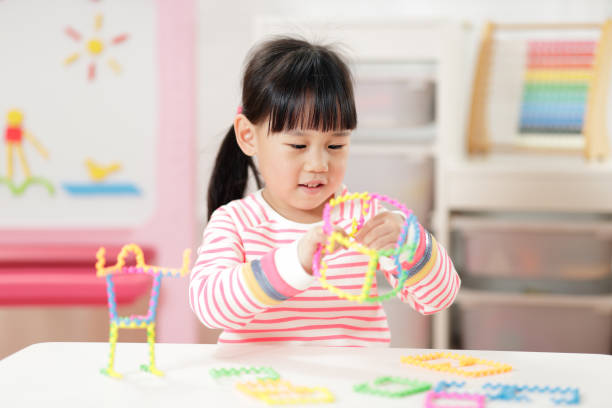 istock Young Girl Playing Creative 3D Shape Toy For Homeschooling 1335549914