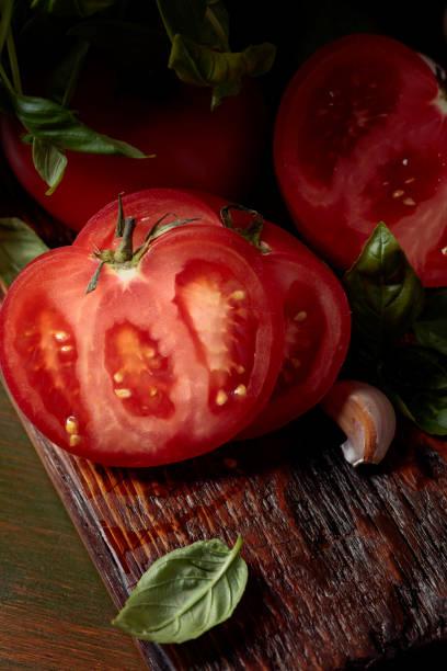 istock Ripe red tomatoes with basil and garlic. 1335551864