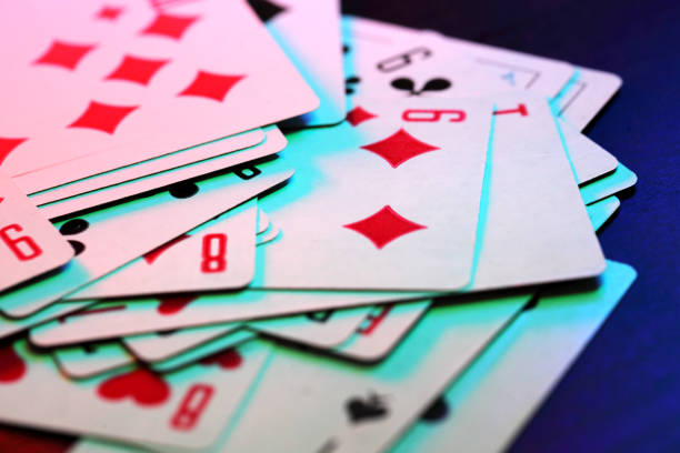 Playing cards Playing cards in colored lighting. bridge hand stock pictures, royalty-free photos & images