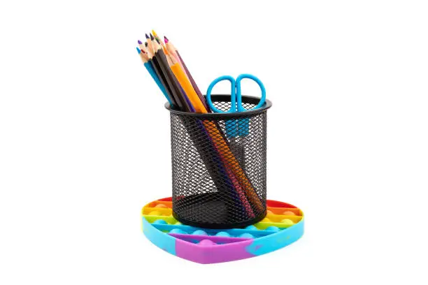 Photo of School supplies, children toy popit anti-stress on white background. Concept of the back to school.