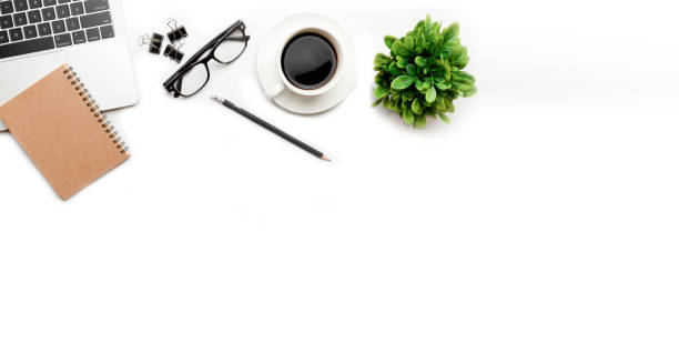 istock Flat lay, top view office table desk. Workspace with blank, office supplies, pencil, green leaf, and coffee cup on white background. 1335553213