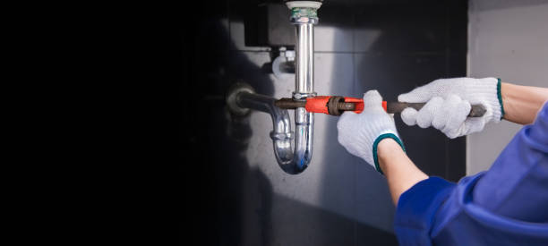 istock Plumber fixing white sink pipe with adjustable wrench. 1335553233