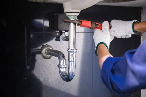 istock Plumber fixing white sink pipe with adjustable wrench. 1335553246