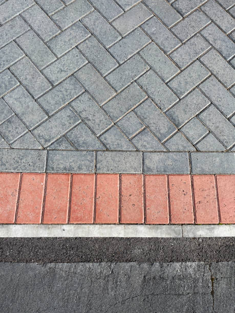 imagem completa da estrutura da pavimentação de blocos de tijolos cinzentos intemperados na calçada moderna / unidade, padrão herringbone, visão elevada - stone paving stone patio driveway - fotografias e filmes do acervo