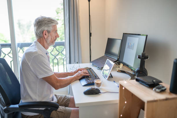 istock Senior man working from home on a remote job in a home office 1335555697