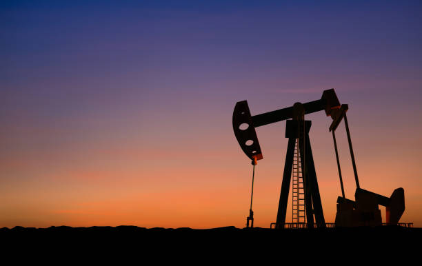 istock Crude oil pump or oil rig sunset 1335557957