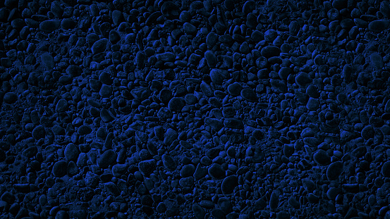 Blue stone texture. Pebbles. Dark rock background with copy space for design. Wide banner.