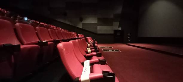 istock Inside a dark movie theater. a red chair 1335558433