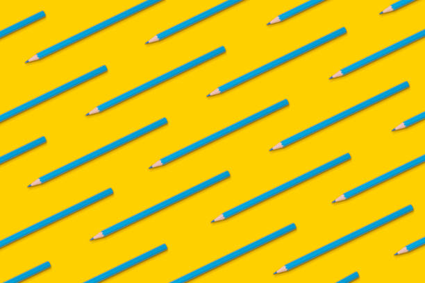 istock Pattern composition of blue pencils on a yellow background. Top view. Flat lay. Back to school concept. 1335558474