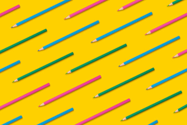 istock Pattern composition of colored pencils on a yellow background. Top view. Flat lay. Back to school concept. 1335558475