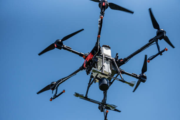 istock Professional agriculture drone flying in the blue sky 1335559038
