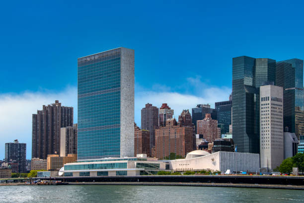 United Nations building in New York New York Skyline seen over the East River from Roosevelt Island with United Nations building. united nations stock pictures, royalty-free photos & images