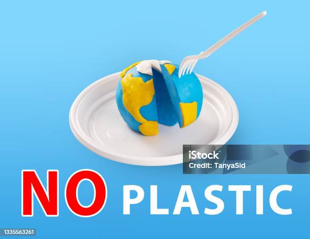 Worldearth Day Concept Plastic Free Concept Pollution Problem Concept A Plastic Plug Stuck Into The Planet Earth Plasticine Earth Model On A Plastic Plate Stock Photo - Download Image Now