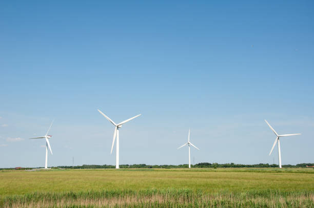 Green meadow with Wind turbines generating electricity stock photo