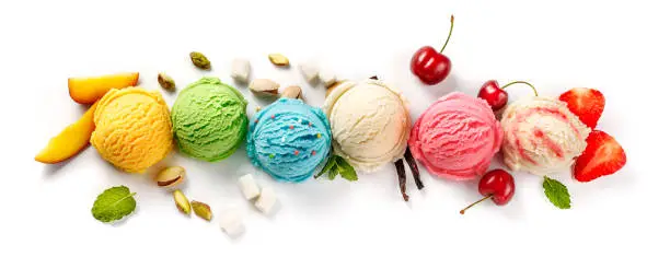 Assorted of ice cream scoops on white background. Colorful set of ice cream scoops of different flavours. Top view of the Ice cream isolated with nuts, vanilla, mint, fruits and berries.