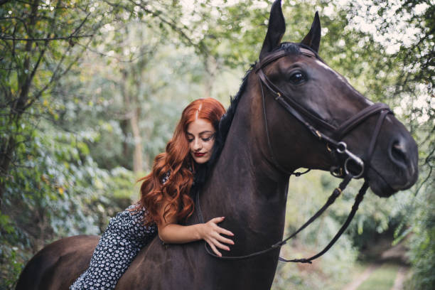 istock Beautiful serene girl spending a tranquil moment with a horse 1335565376