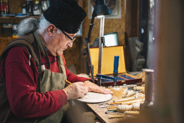 istock Senior adult artisan making decorative figurine 1335570163