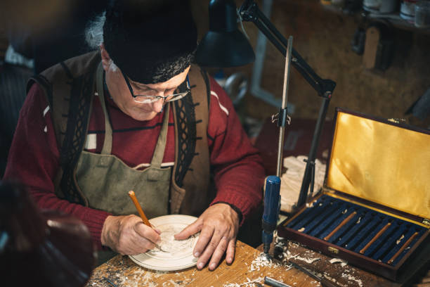 istock Senior adult carpenter working in his studio 1335570164