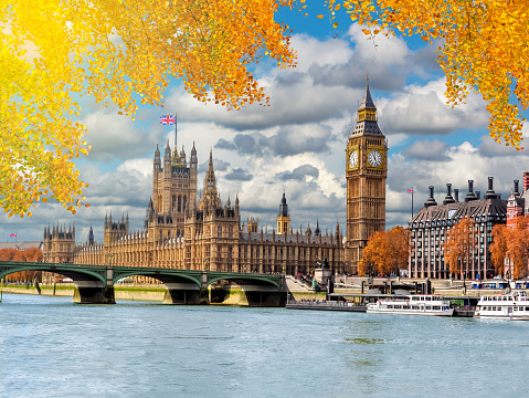 Big Ben tower with Houses of Parliament and Westminster bridge in autumn, London, UK