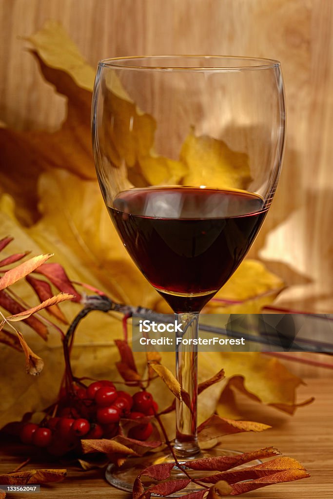 Wine and leaves Wine and autumn leaves over wooden board Alcohol - Drink Stock Photo