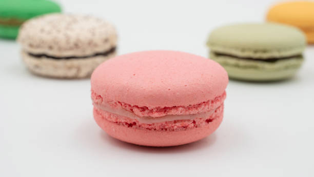 istock Multiple flavor Cake macaron or macaroon on turquoise macros on a white background. 1335623151