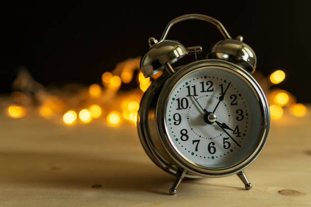 istock Alarm clock with Christmas lights 1335623761