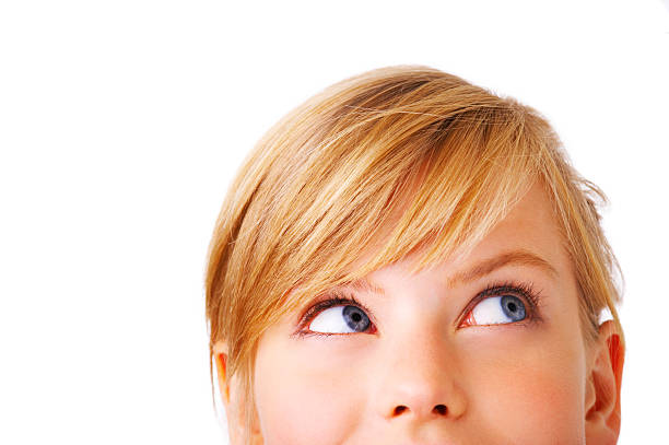 Whats that up there? Close-up portrait of a beautiful teenager. Looking up into the corner. Lots of copyspace and room for text on this isolate. sideways glance stock pictures, royalty-free photos & images