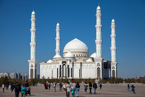 Exterior view The Hazrat Sultan Mosque in Astana capital of Kazakhstan.People walking in independence square.Nur Sultan,Kazakhstan.1 May 2017