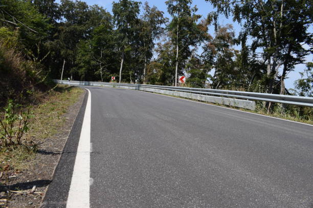 istock mountain road in the forest 1335663805