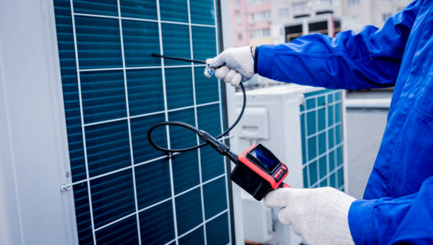 the technician uses a digital camera to check the clogging of the heat exchanger the technician uses a digital camera to check the clogging of the heat exchanger. Air Exchanger stock pictures, royalty-free photos & images