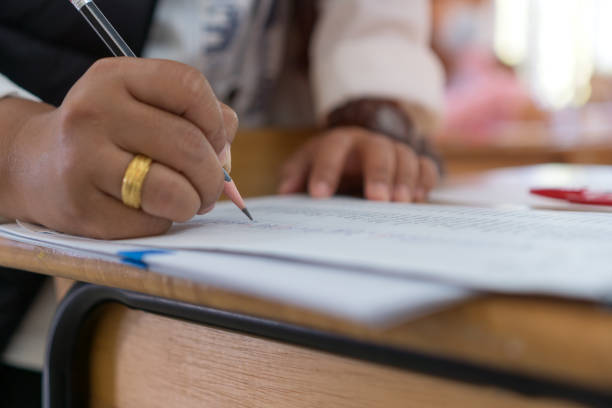 istock Adult learning for student university study in class, hand note lecture in notebook for exam. Adults education is practice in engage systematic, sustained self-educating activities in knowledge skills 1335665790
