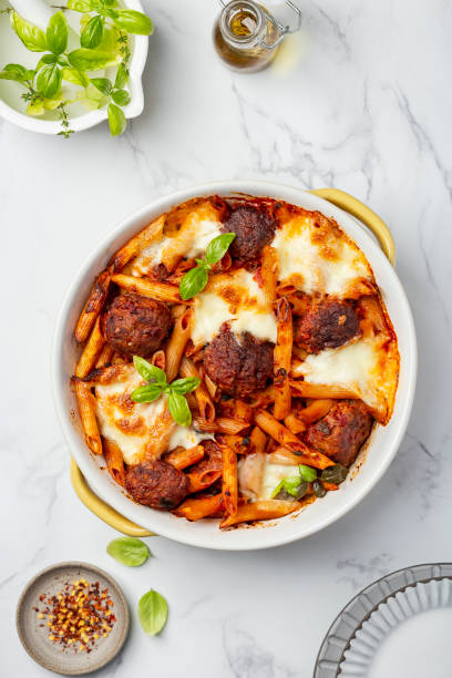 baked penne pasta with meatballs and mozzarella baked penne pasta with meatballs and mozzarella in tomato sauce penne meatballs stock pictures, royalty-free photos & images