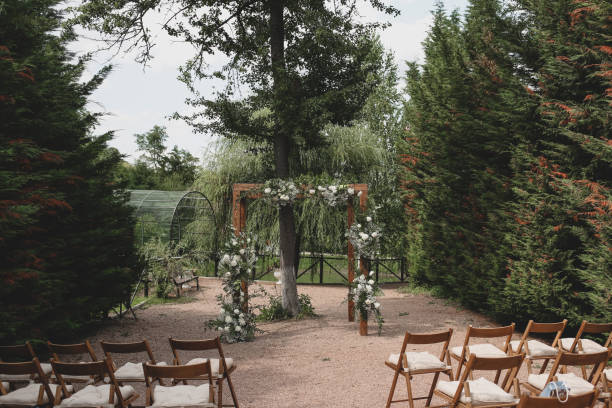 istock Rustic wedding arch for an ceremony decorated with white and flowers. 1335670600