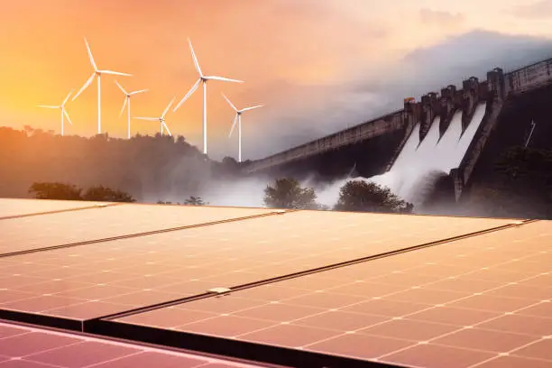 Electricity from solar panels, dams, and wind turbines. Environmentally-friendly renewable energy concept.
