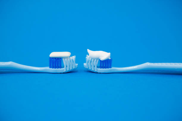 istock Blue toothbrushes on a blue background. Protecting teeth from caries. 1335672686