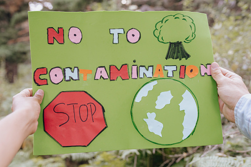 hands holding a banner of caring for the environment nature