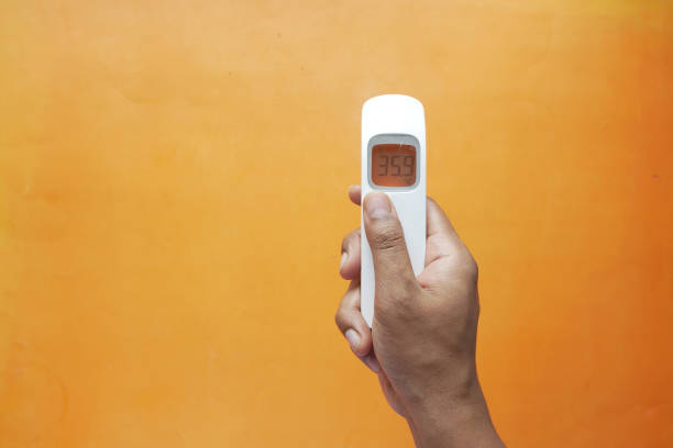 istock Hand holding infrared thermometer to measuring temperature. 1335673825