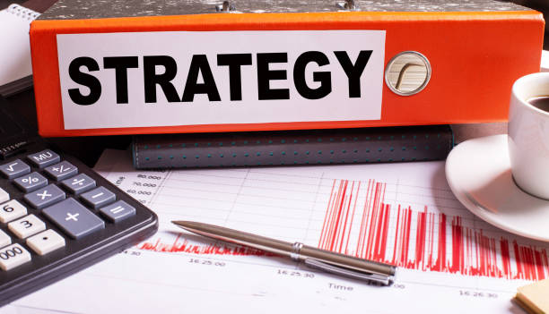 istock STRATEGY is written on the red folder next to the calculator, charts and pen 1335675822