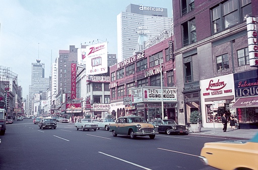 Manhattan, New York City, NY, USA, 1964. Street scene with dance halls, cinemas, advertising signs, buildings, shops, passers-by and traffic on famous Broadway, Downtown Manhattan.