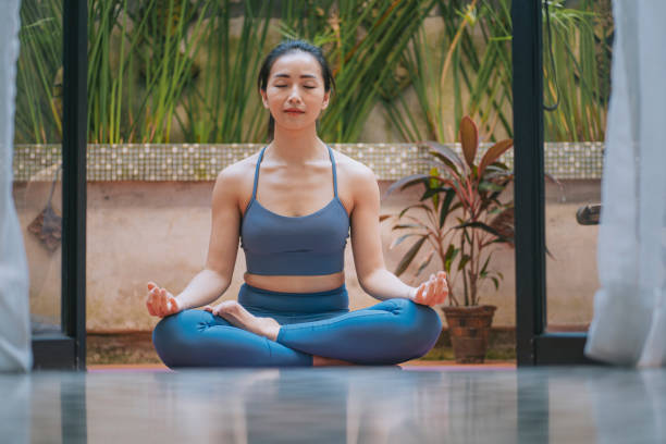 asiatische chinesische schöne frau yoga meditation workout im vorgarten ihres hauses - floor women sitting yoga stock-fotos und bilder