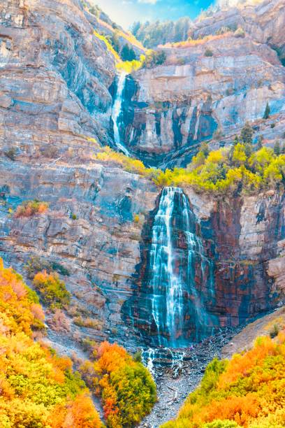 istock Tranquil autumnal background cascading waterfall - stock photo 1335681498