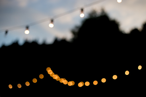 Decorative outdoor string lights at night time, Defocused Background, night city life, party time