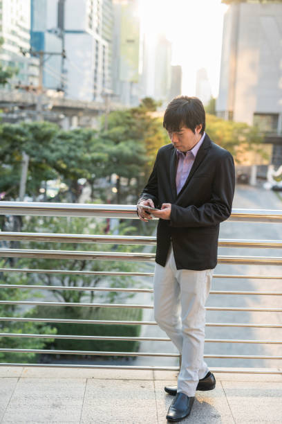 istock Korean Businessman ceo using smartphone in city 1335683039