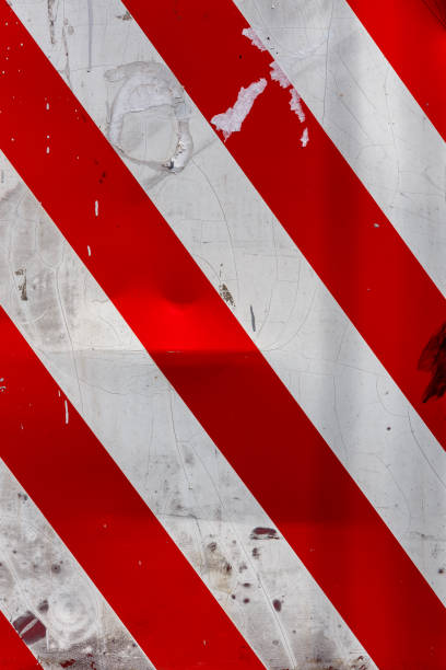 istock red and white diagonal stipes on flat steel sheet - caution road sign 1335686873